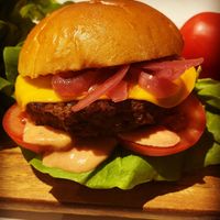 1/4lb cheeseburger with lettuce tomatoes homemade burger sauce pickled red onions  at Greedy Vegan in Chelmsford