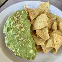 Thick avocado toast with mustard seeds, and they serve with tortilla chips - very salty and carb heavy at Active Culture in Novato