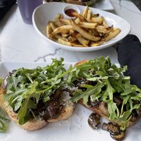 Mushroom arugula toast with truffle fries   at Coco Bistro & Bar in Chapel Hill