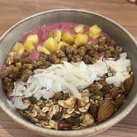Pink Pitaya bowl with in house made granola, fresh coconut, banana and dragonfruit  at The Sane Sister  in Willemstad