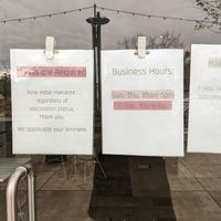 2021 store hours posted at entrance at RawASF in Fremont