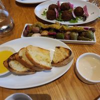 Grilled bread, olives and pickled garlic, falafel with tahini at Chloe in Washington