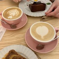 Cappuccino, cinnamon roll, and chocolate cake at Sakura in Berlin