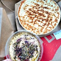 Side of pita and hummus. Definitely add another piece of pita, it wasn't enough. at Shouk in Rockville