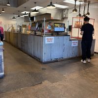 Small take out area with a few tables on the leftt  at Shouk in Rockville