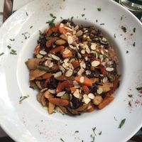 Brown rice noodles in peanut butter sauce with lots of different veggies and some blanched almonds on top at Avocado in Athens