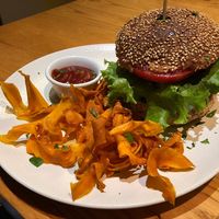 Burger with thin sweet potato fries and spicy ketchup at Avocado in Athens