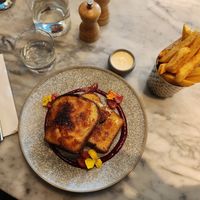 Crème brûlée brioche french toast with raspberry compote and vanilla cream. Also, lemon pepper fries. at Mallow - Borough Market in South East London
