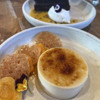 crème brûlée, vanilla thyme poached apricot, apricot coulis, lemon snap and dark chocolate passion fruit sachertorte, chantilly, mendiant  at Mallow - Borough Market in South East London