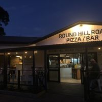 The front area, with picnic style tables around the corner and hanging lights which create a lovely atmosphere.  at Round Hill Road in Agnes Water