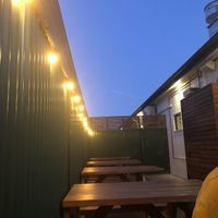 Towards the back area of the restaurant. Hanging lights and picnic tables create a lovely, relaxed atmosphere.  at Round Hill Road in Agnes Water