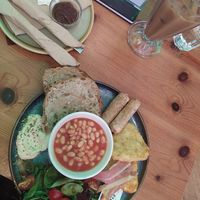 Vegan english breakfast with hummus, sausages, beams, hash browns and bacon at kave in West London