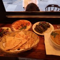 Makdous aubergine, houmous Beiruty, bread, vine leaves and lentil soup at Palmyra's Kitchen in North London