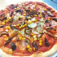 They only have 4 vegan topings. Corn, mushrooms, onion and olives. I took three of them. Stuff is really friendly. at Pizza Here in Ha Giang