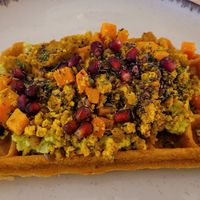 Sweet potato waffle with tofu scramble and avocado cream at Wake & Waffle in 