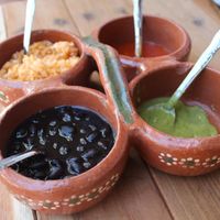 Selection of Homs made sauces and black beans   at La Vegan Taqueria in Tulum