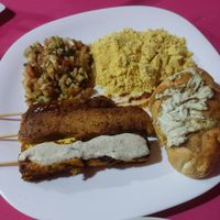 Chickpea sausage, sunflower seed cheese and tofu on a stick. Garlic bread. Vinagrete and farofa! at VeganFit in Parnamirim