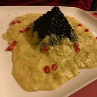 Black Veneto rice risotto with leek cream and pomegranate at L'Angolo Divino in Acqui Terme