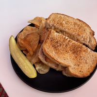 Vegan Reuben served with chips and a pickle  at Avanti in Boulder