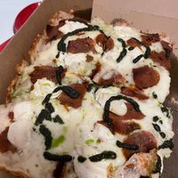 Detroit style vegan pizza with pepperoni, ricotta, pesto  at TNT Pizza in San Diego