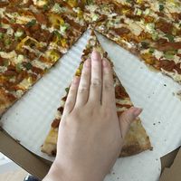 my hand compared to a slice for size   at TNT Pizza in San Diego