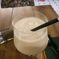 A banana date smoothie with paper straw at Hustle n' Flow in 