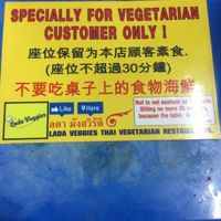 sign on the table at Lada Vegetarian Food - Veg Stall in Chiang Mai
