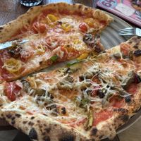 Vegetarian and four tomatoes pizza (sorry, I started eating before taking the picture 😅)  at Lil' Italy in Vienna