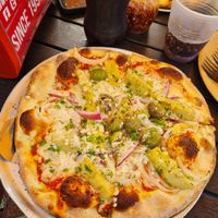 Pizza with vegan cheese, artichokes, olives and red onion at Pizza Rustica in Miami Beach