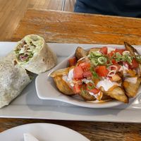 The seitan wrap with a side of loaded potato wedges.  at Rise Above in St Catharines