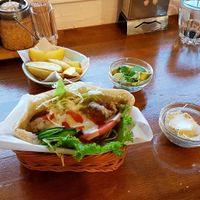 Pita falafel with potato wedges, hummus and avocado on the side. at Falafel Garden in Kyoto