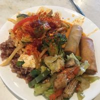 Buffet pile of rice, veggies, red curry, and tasty spring rolls at Araya's Place - University District in Seattle