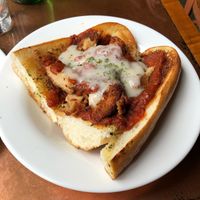 Sandwich with marinara sauce, vegan cheese, and faux meat at Seasoned Vegan in New York City