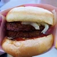 Vegan double cheeseburger with tomato, lettuce, pickle, and dressing at Herbie's Burgers in Albany