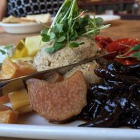 Paté Platter: Lentil-pecan paté, red onion confit, house made pickles, croccantini, fresh fruit. at Cafe Flora in Seattle