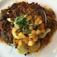 Summer Yuca Cakes: Cassava & carrot cakes, sweet pepper sofrito, baby summer squash & spicy peach chutney. at Cafe Flora in Seattle