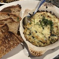 Warm Kale Artichoke Dip with baked in-house sourdough   at Cafe Flora in Seattle