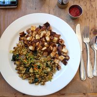 The vegan version of the Summer Squash Scramble. Seasoned tofu, sauteed summer squash & zucchini grilled Vidalia onions, kale, squash blossoms and a side of potatoes.  at Cafe Flora in Seattle