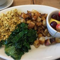 vegan breakfast platter : scrambled spiced tofu, potatoes, steamed kale and fruits at Cafe Flora in Seattle