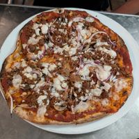 fully loaded vegan pizza at The Orange Street Grocer in Speightstown