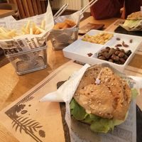 Pickled beans, olives, nuggets, vegan burger and fries.  at Lima Bar in Viana Do Castelo