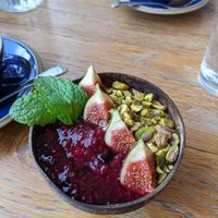 Goawesome porridge with pistachio, figs and compote in coconut bowl at Hata in Edinburgh