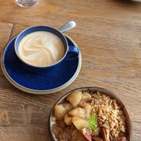 Goawesome porridge with apples, granola, pecans in coconut bowl at Hata in Edinburgh