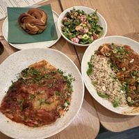 Two mains a side salad and cinnamon bun   at Cultivate Food in Oslo