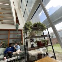 Communal table and chill out spot on the sofa  at Hablemos Coco Cafe in Puerto Natales