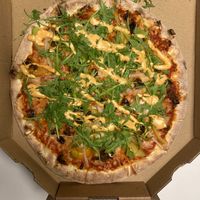 Grænkerinn vegan pizza (Sauce, vegan cheese, garlic, dates, onion,
 green paprika, rugula, spicy mayo, black pepper) at Reykjavik Pizzeria in Reykjavik