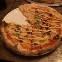 Pizza with vegan cheese, onions, bell pepper, dates and vegan chili mayo at Reykjavik Pizzeria in Reykjavik