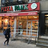 Front of pizza parlor, with some outside seating. at Pizza Park in New York City