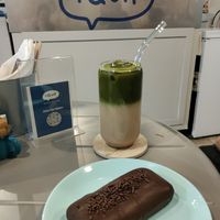 Horchata matcha and cake covered in chocolate with cream and jam inside at I Quit - Café & Bakery in Mexico City
