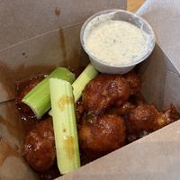 Cauliflower wings appetizer with barbecue sauce instead of buffalo. Side of ranch included.  at Envegan in East Point